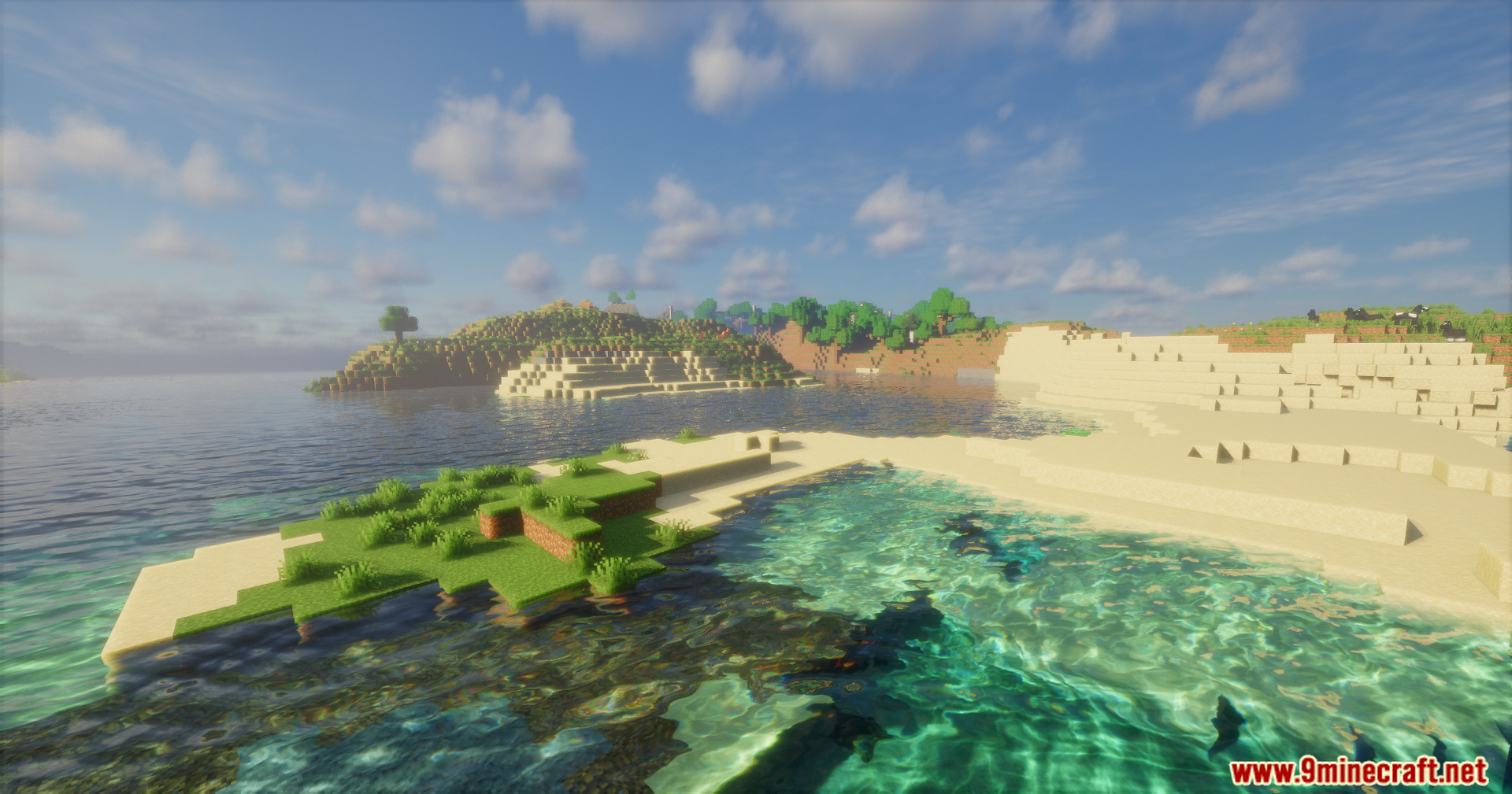 Beautiful clear reflective water near a sandy beach and grassy island