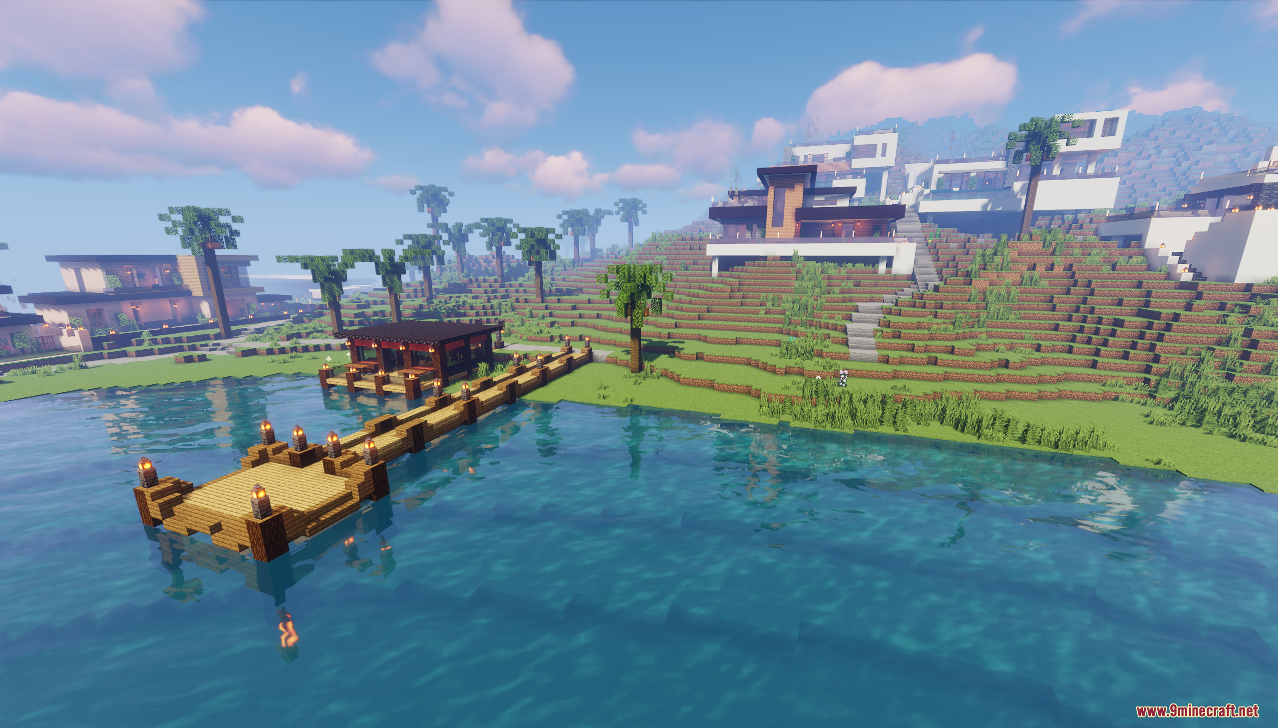 Wooden dock on the water with modern houses in the background