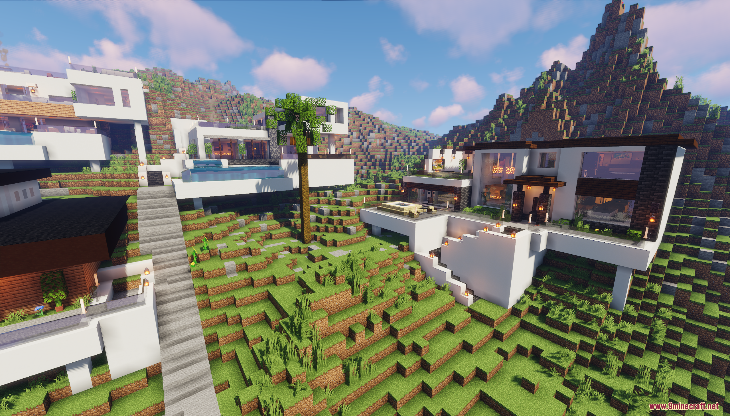 White modern houses on a grassy hill with long stone stairs