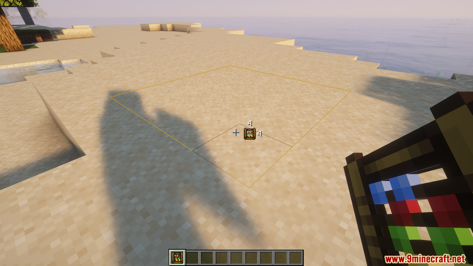 Player using an abacus tool to measure a square area on sand