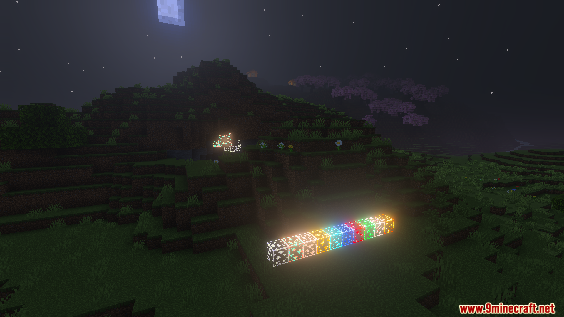 Glowing outlined ore blocks shining brightly on the grass at night