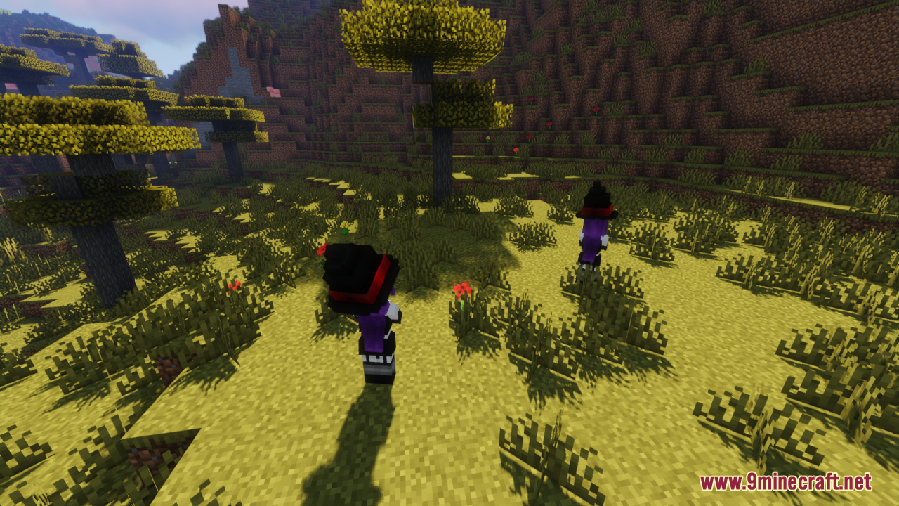 Two witch girls standing in a sunny, tree-filled landscape
