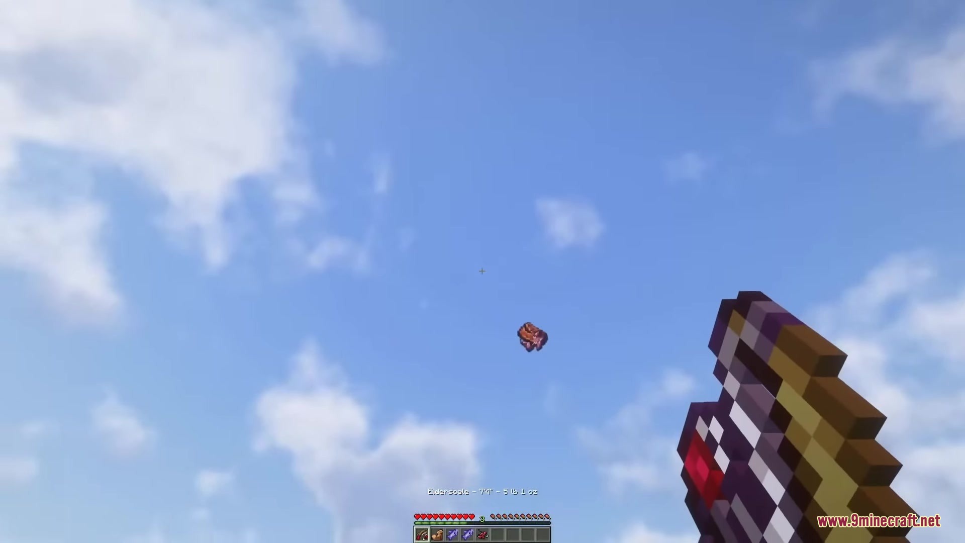 A player holding a fishing rod watches a fish flying in the sky