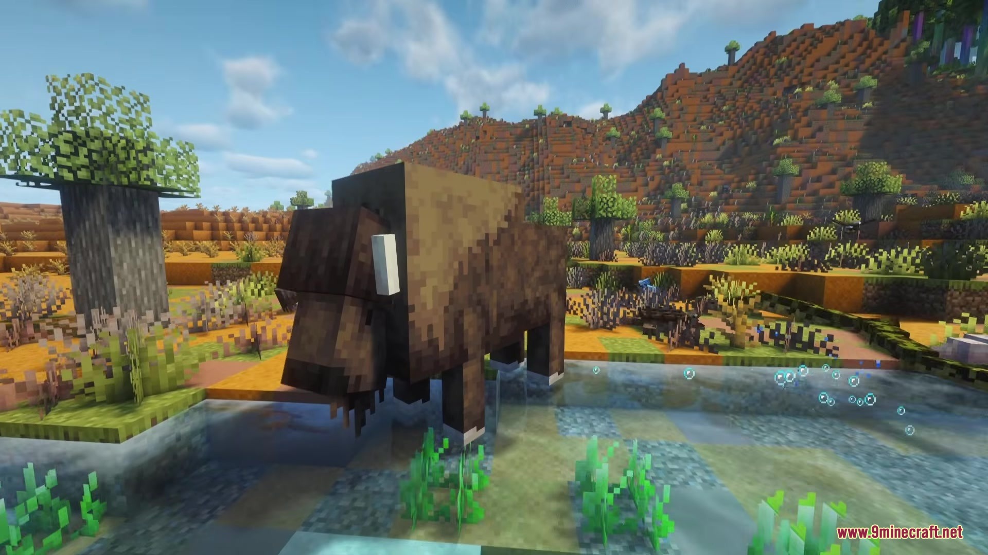 Alex’s Mobs Fabric Mod (26.2, 1.20.1) – Populate Every Biome With Exotic 2 A large brown bison standing in shallow water in a savanna biome