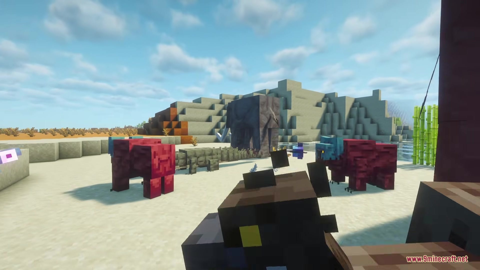 Alex’s Mobs Fabric Mod (26.2, 1.20.1) – Populate Every Biome With Exotic 10 A large grey mammoth and red creatures standing on a sandy beach
