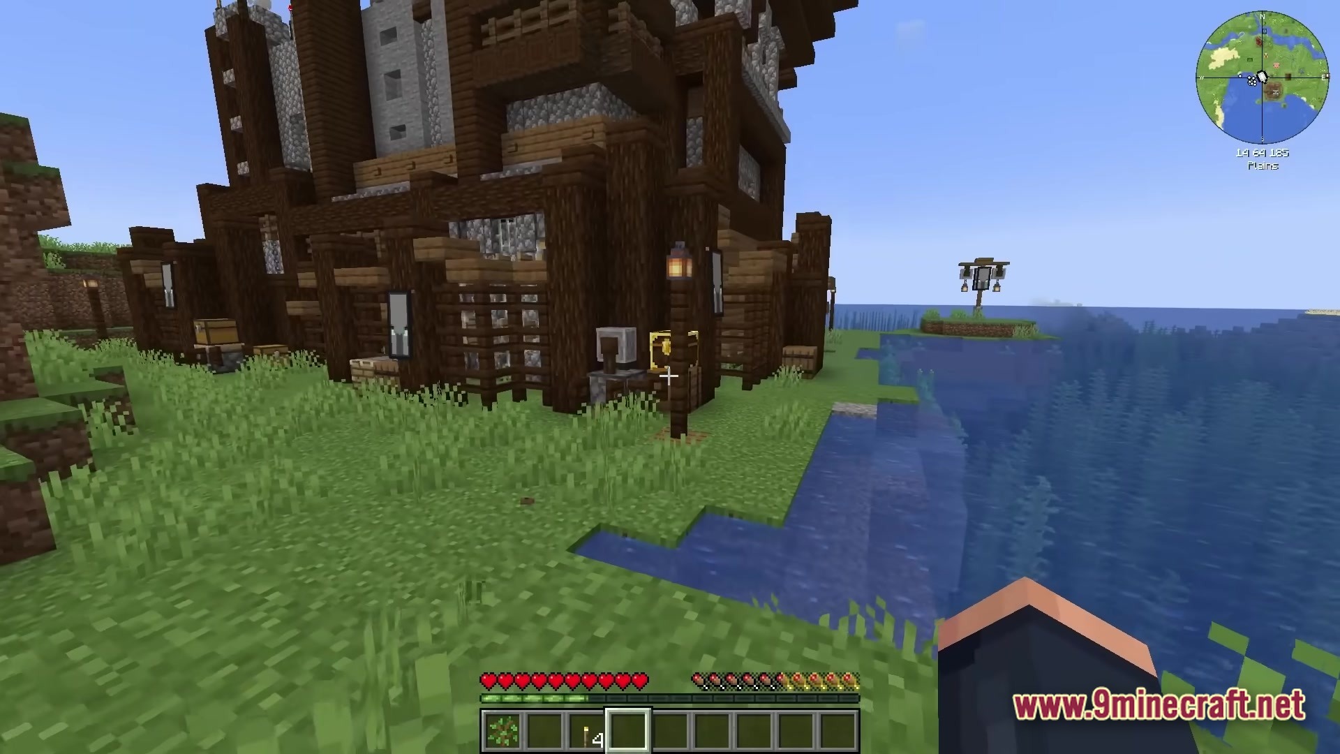 All The Mods 10 To The Sky Atm10 Sky Modpack (26.2, 1.21.1) – Build Your Empire 2 A large wooden and stone structure stands on a grassy island overlooking the ocean