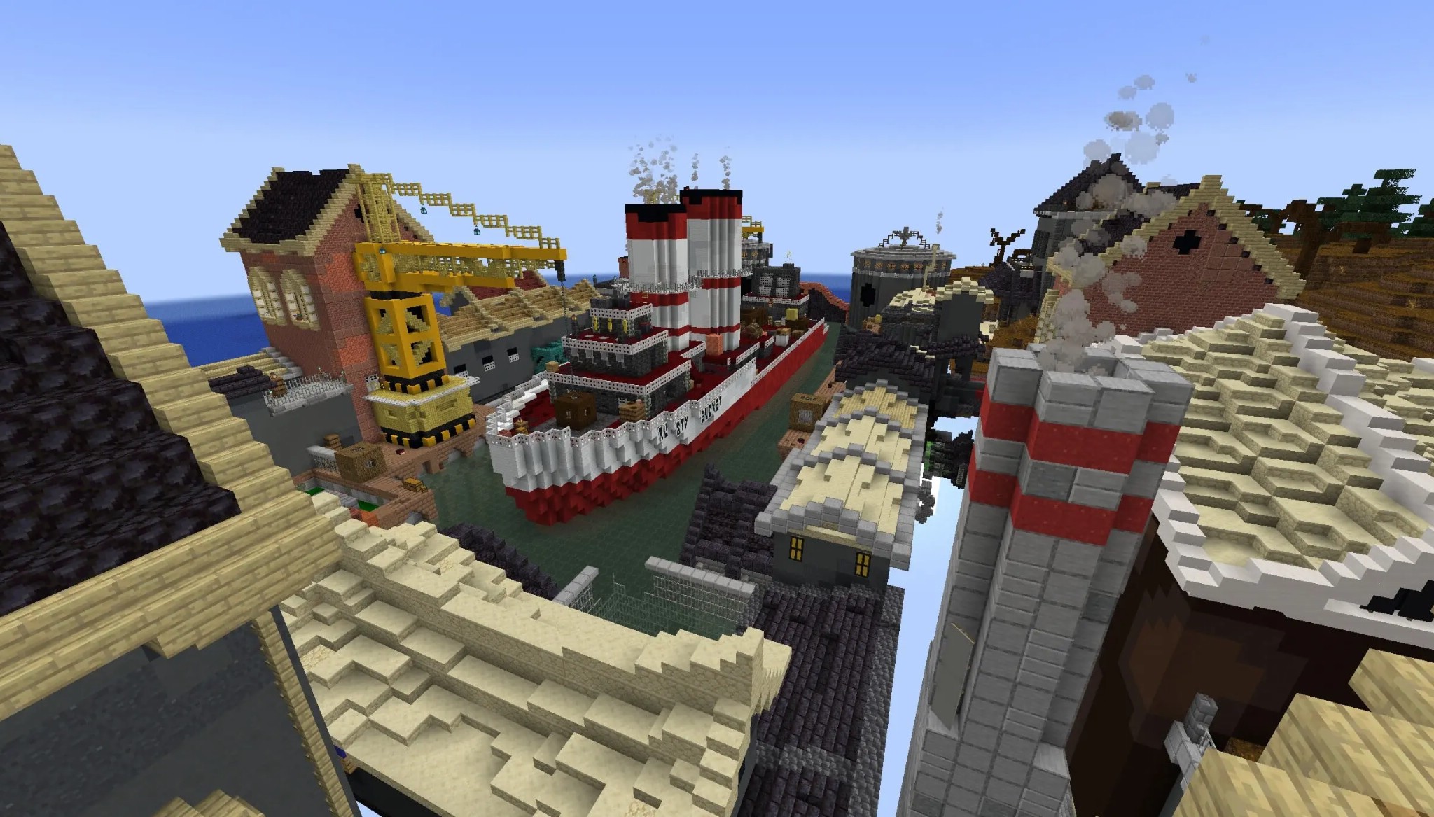 A large red and white ship docked next to a yellow crane