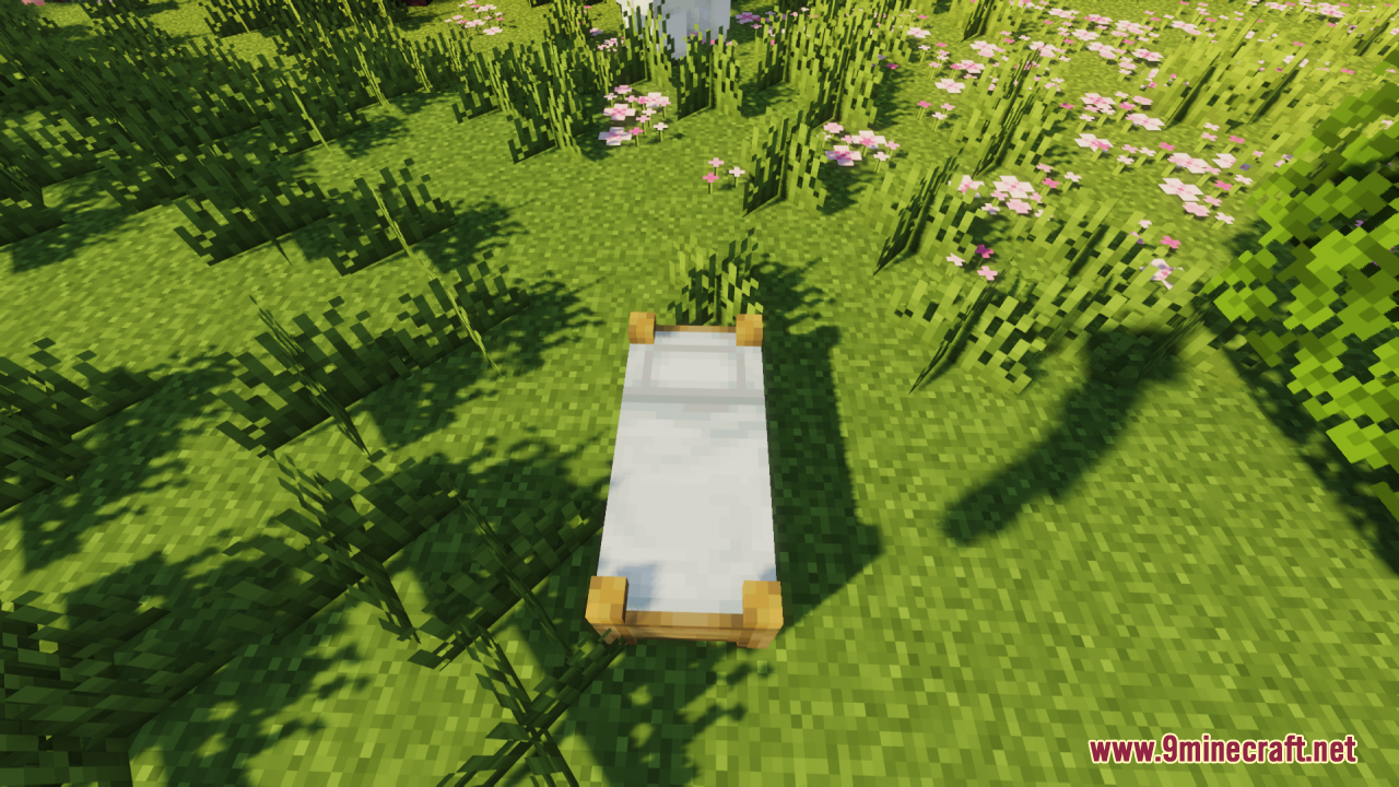A white bed with detailed wooden legs placed on a flowery field
