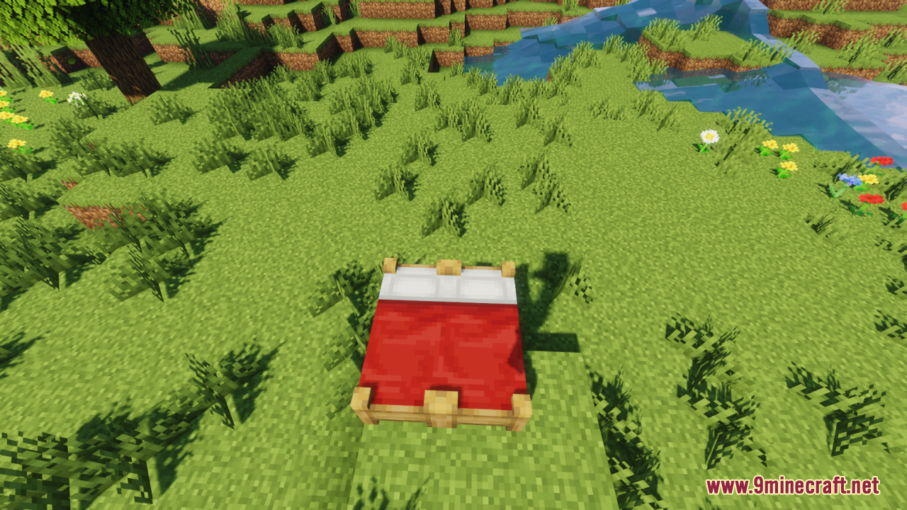 A red double bed with a wooden frame placed on green grass