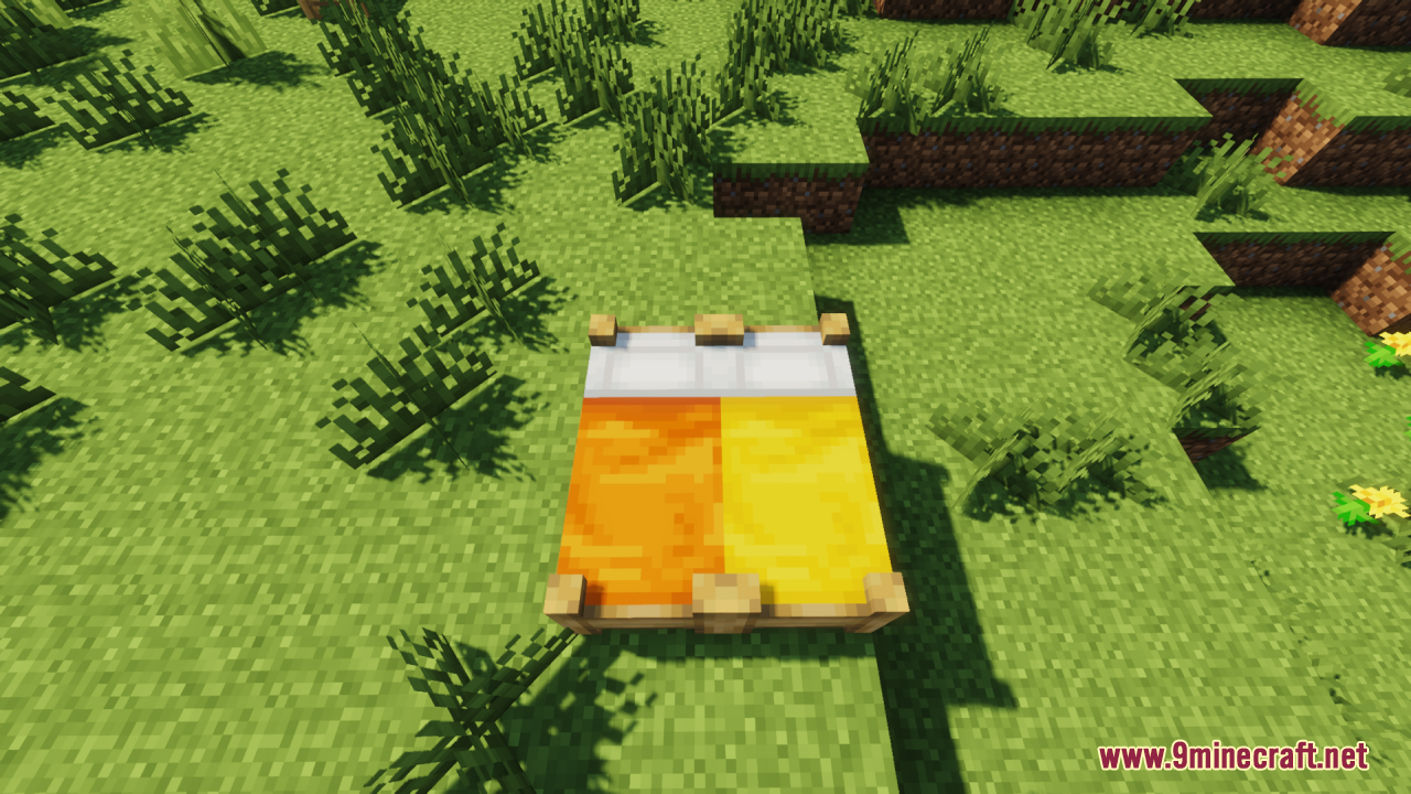 Orange and yellow double bed with a wooden frame in a grassy field