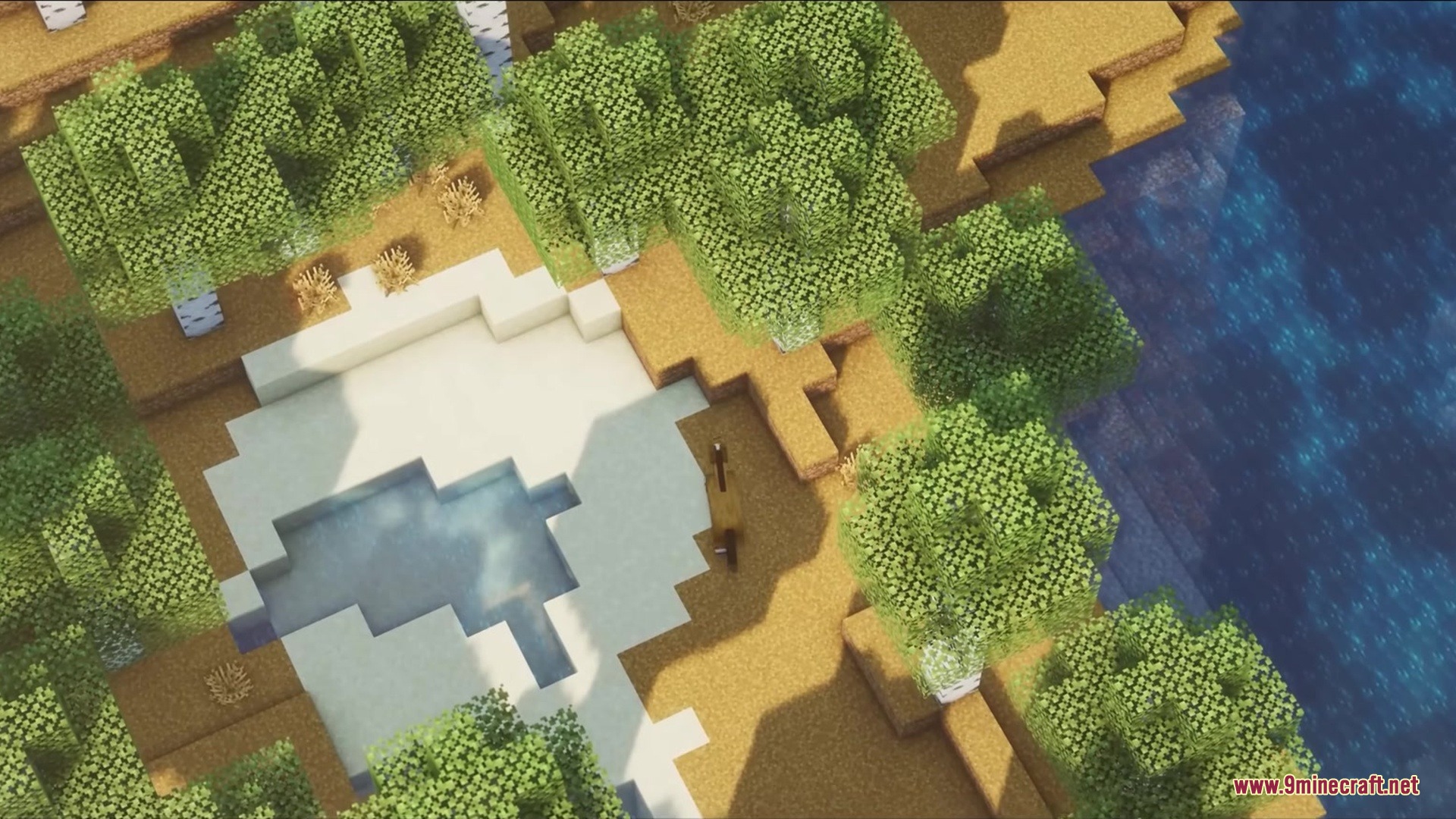 Blak Suit’s Bushy Grass Resource Pack (1.21.11, 1.20.1) 3 Aerial view of a minecraft landscape with dense foliage and clear blue water