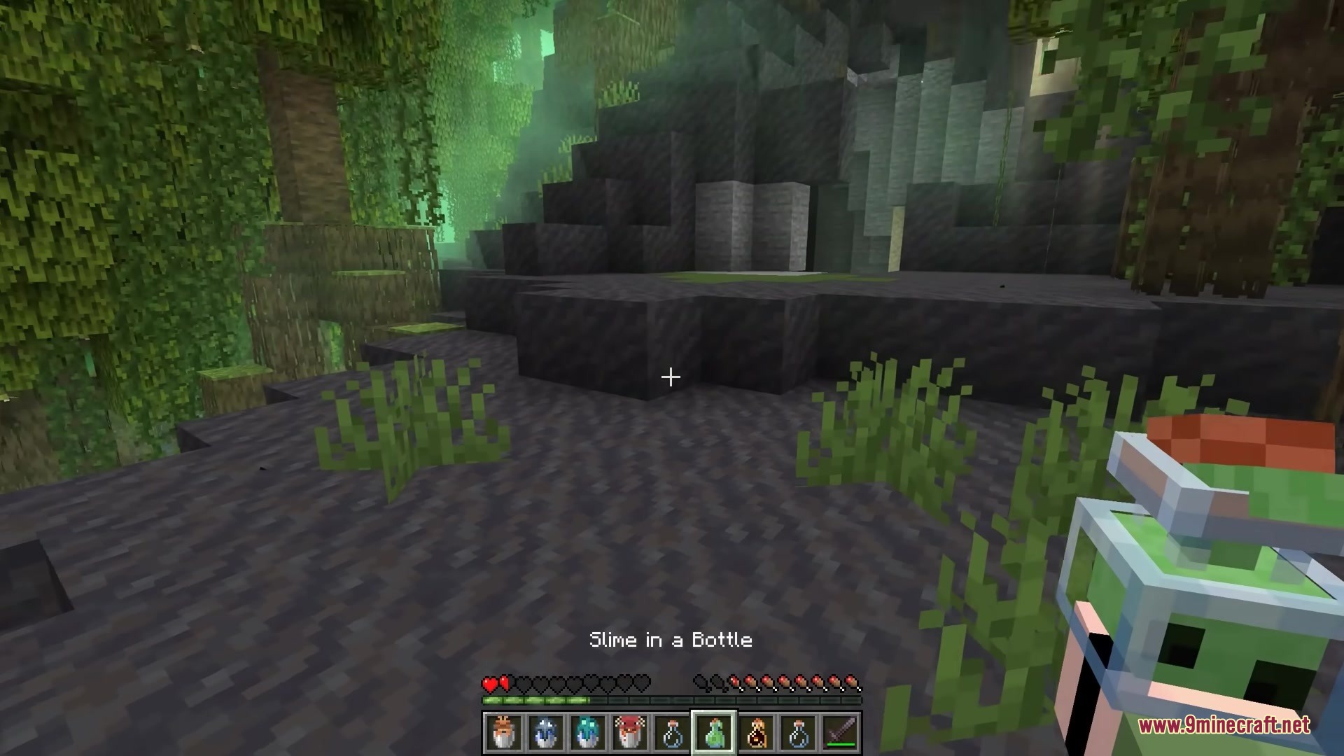 Bucketem Remodeled Resource Pack (1.21.11, 1.21.1) – Lifelike 3D Mobs 3 The player holds a captured slime inside a detailed 3d glass bottle