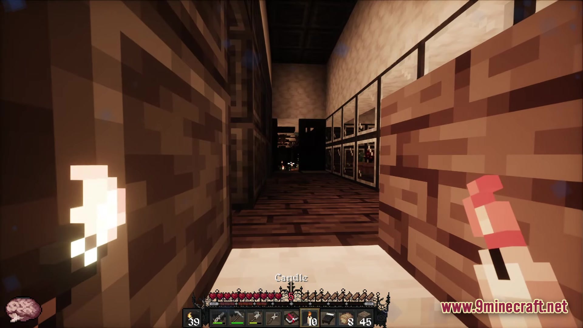 Fear Nightfall Remains Of Chaos Modpack (26.2, 1.20.1) – Survive The Endless Nightmare 3 A player explores a dark interior hallway while holding a lit candle and a red item