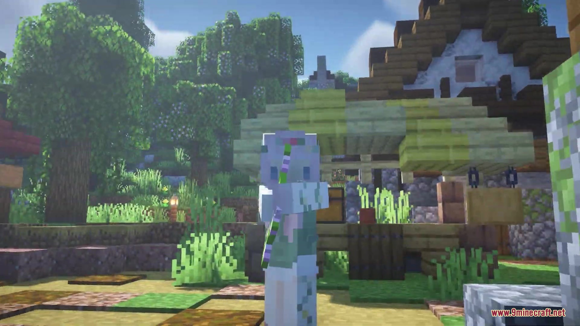 Flowering Oak Leaves Resource Pack (1.19.2, 1.18.2) – Springtime Blossoms 6 A minecraft character stands in a village with trees showing small colorful blossoms
