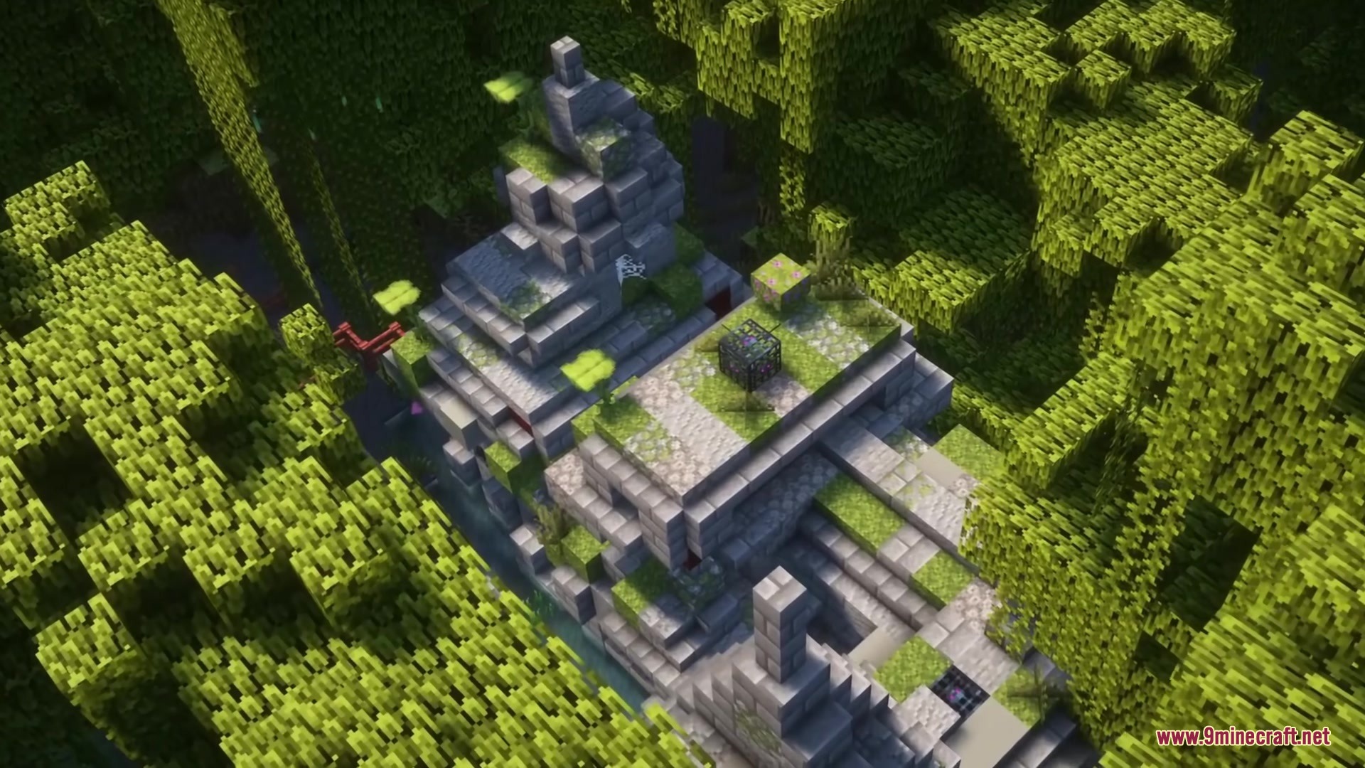 Overgrown stone ruins with a mob spawner located in a dense green jungle
