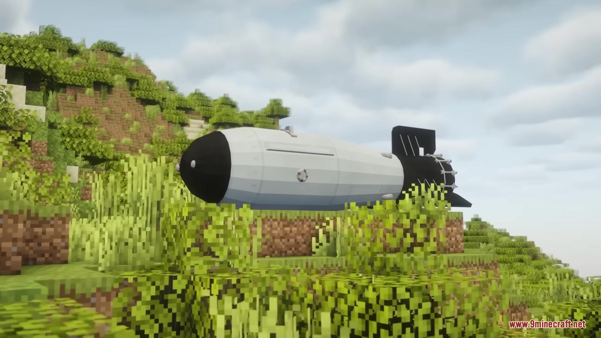 Hbm Ntm Rebirth Mod (1.20.1) – Build Nuclear Reactors And Detonate Massive Bombs 7 A massive white and black nuclear bomb resting on a grassy hill