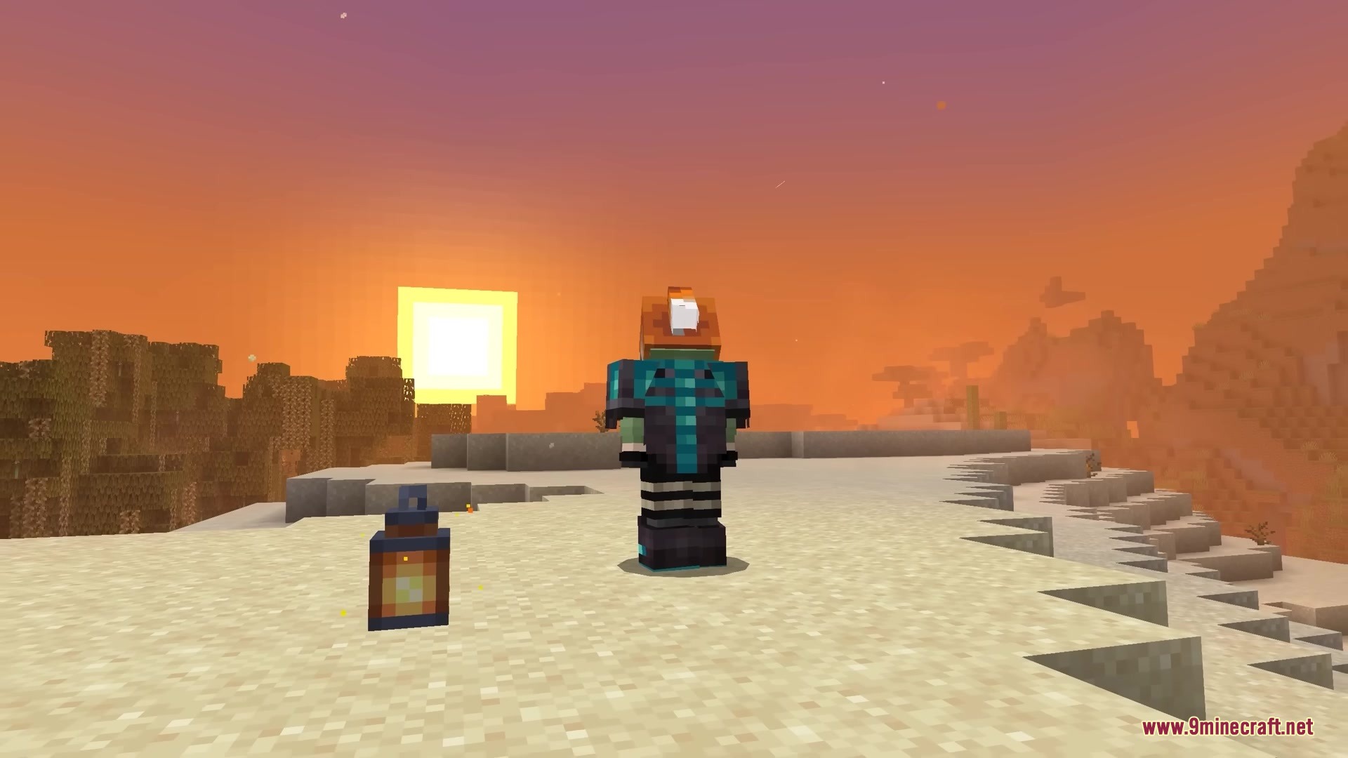 A player character wearing custom armor stands on a cliff during a sunset