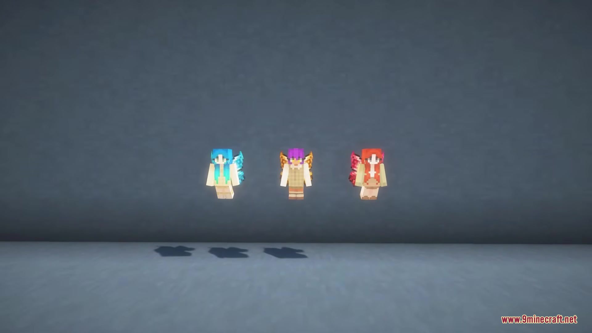 Three small winged characters with colorful hair floating against a gray background
