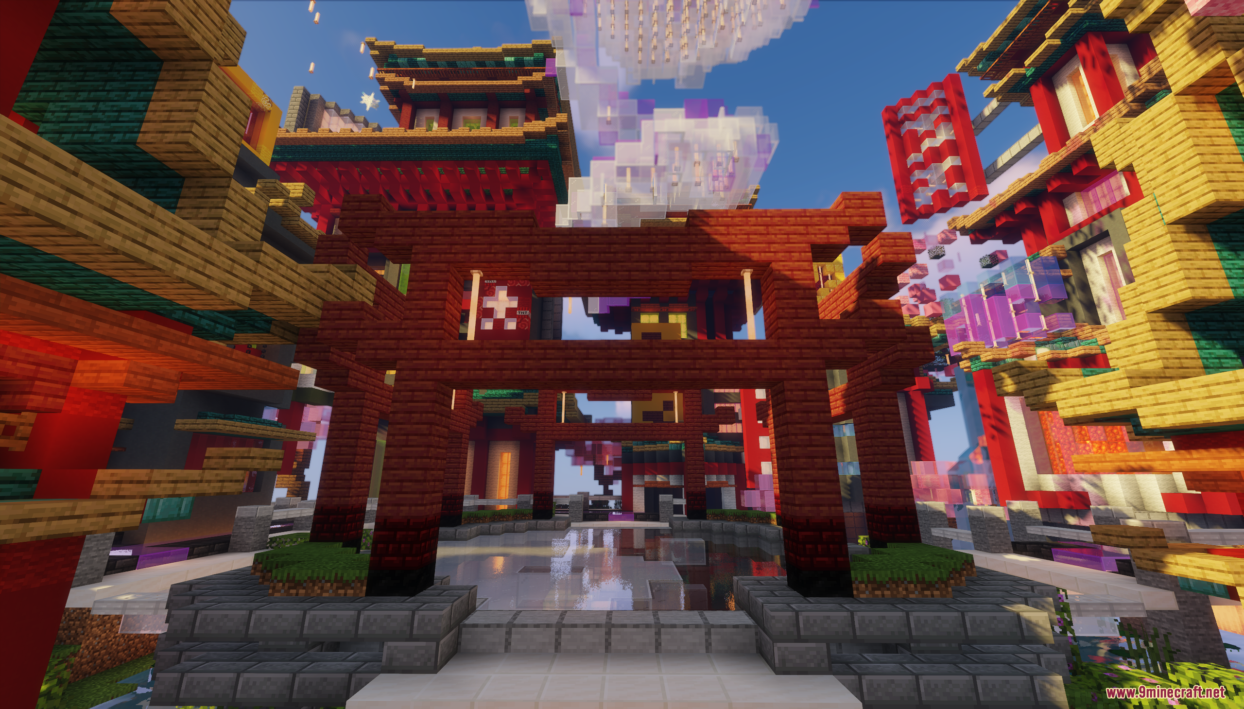 A large red torii gate standing before a complex of traditional oriental buildings