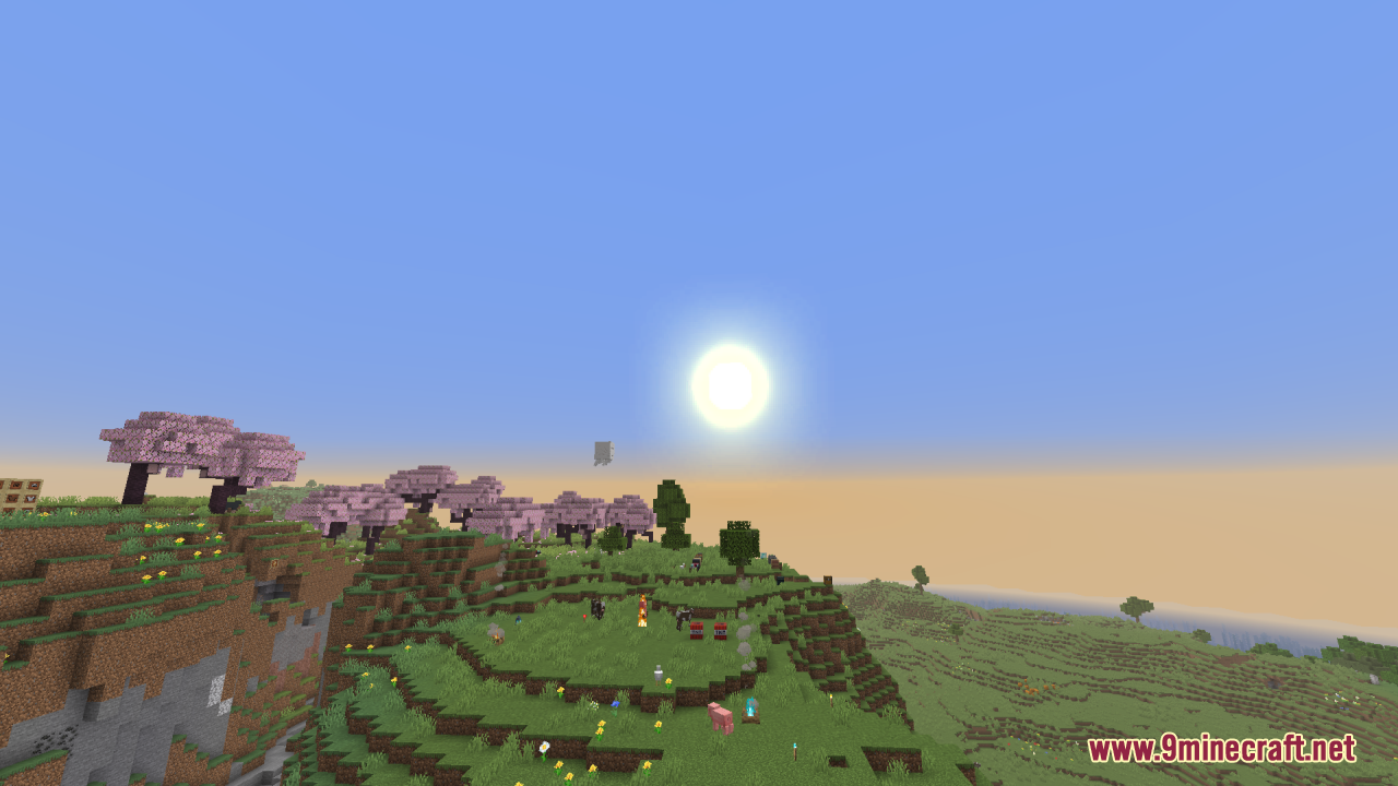 The bright sun shining over cherry blossom trees and green hills