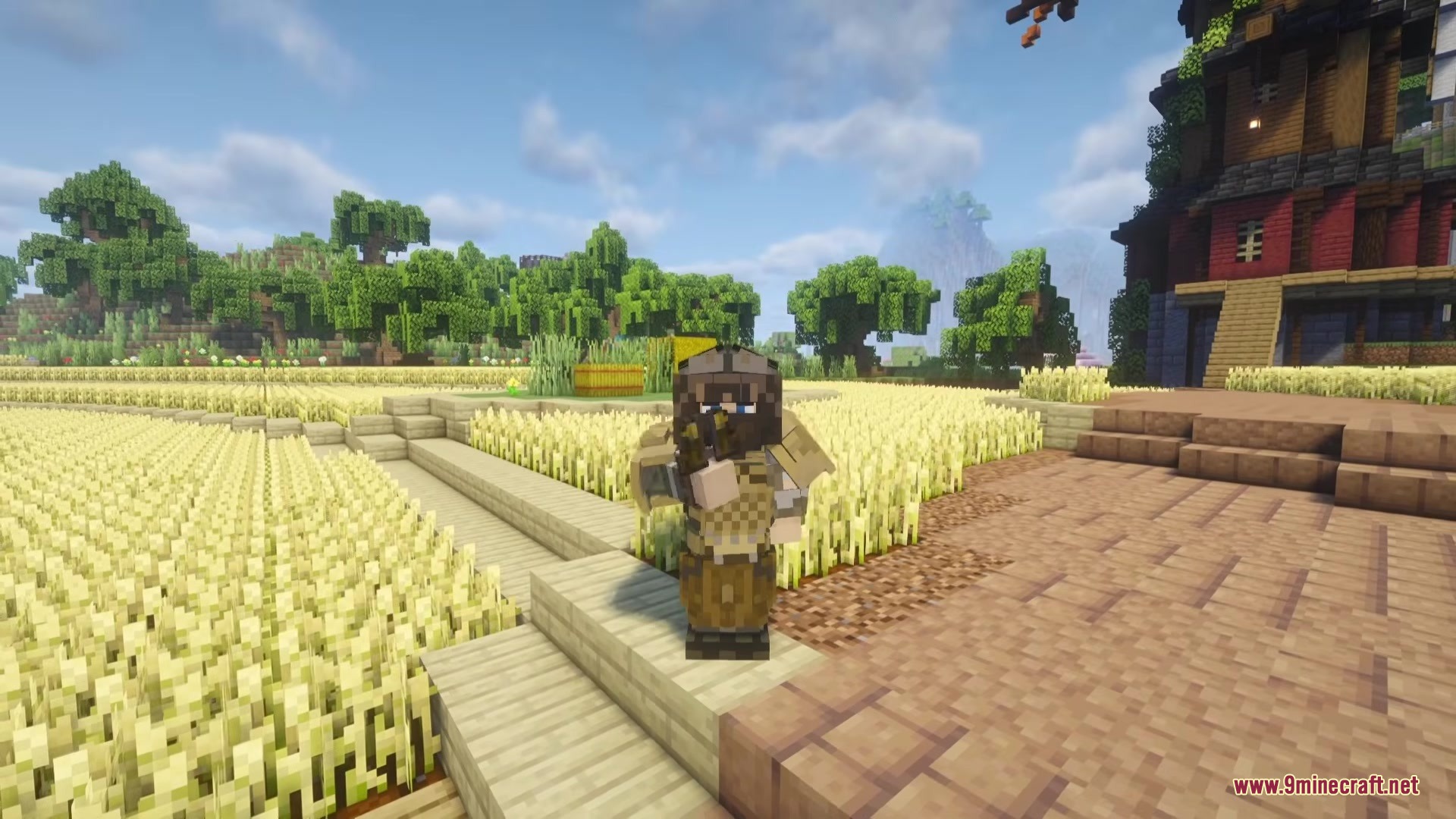 Tacz More Level Mod (1.20.1) – Fight Armed Enemies With Tiered Tactical Gear 7 A player wearing tactical armor holds a gun in a golden wheat field
