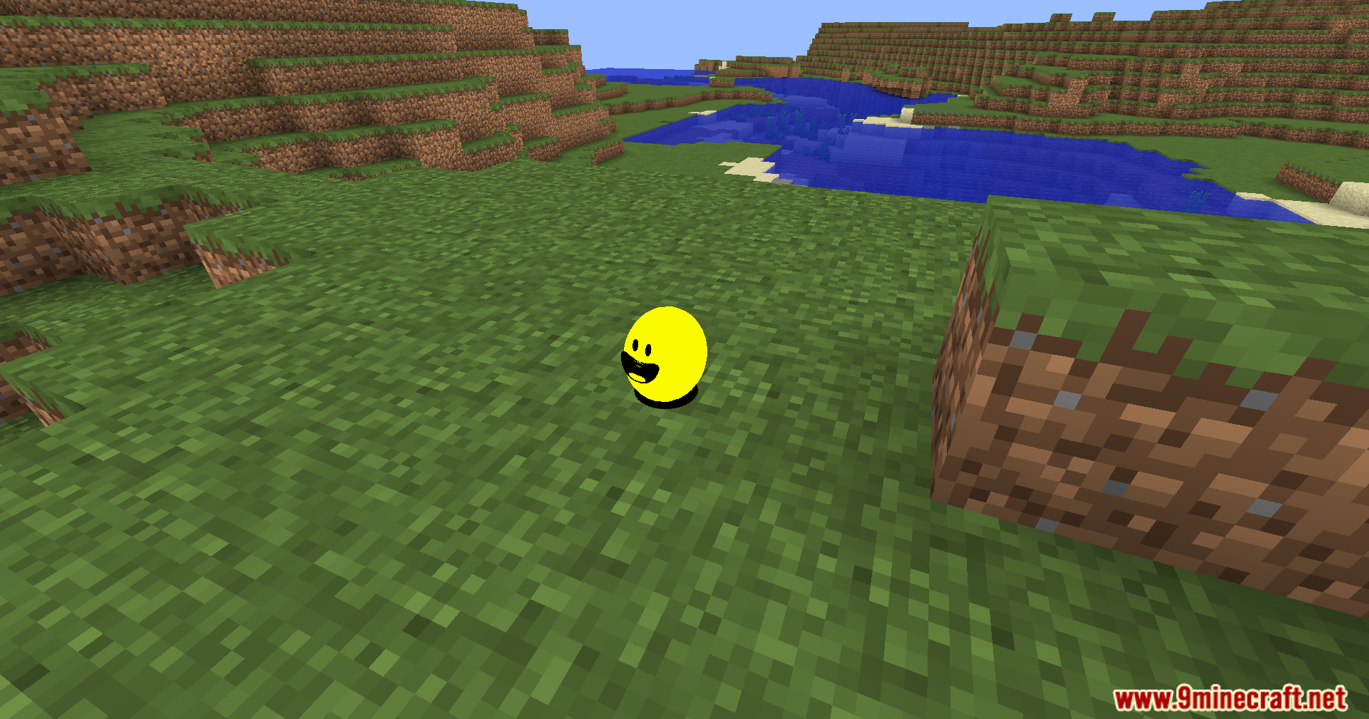 Verity Shaders (1.20.1) – Smooth Sphere Rendering For The Verity Mod 7 The smooth yellow sphere rests on a grassy field near a blue river
