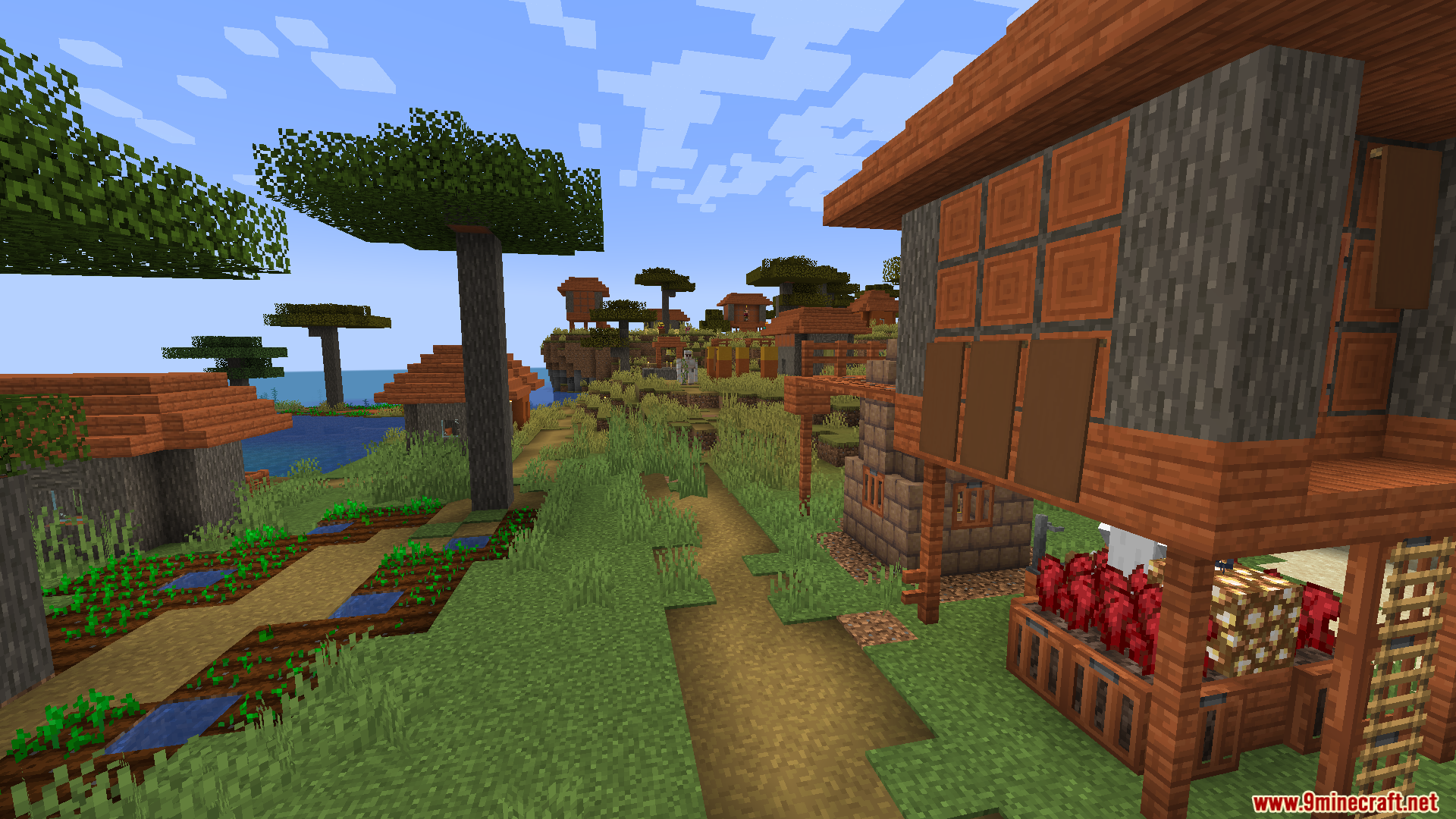 Savanna village with custom buildings and a villager walking on a path