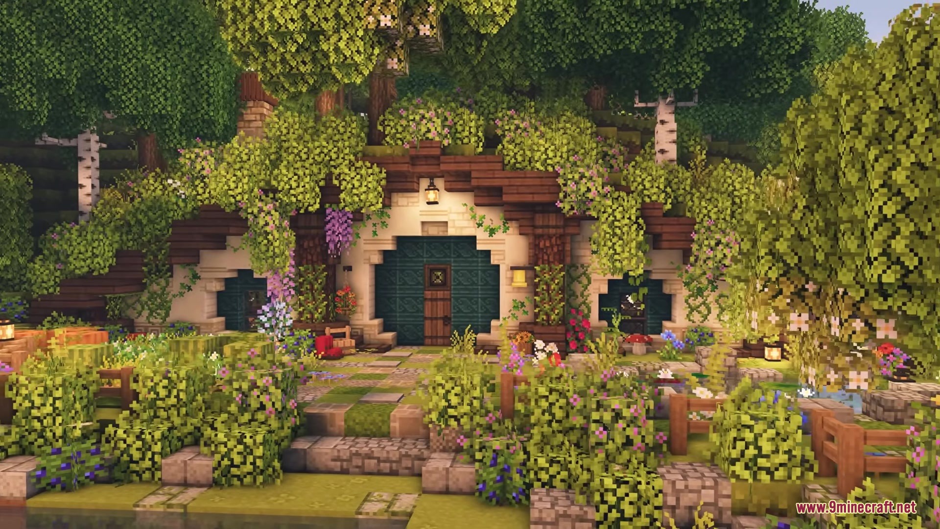 Cozy hobbit style house built into a hill with beautiful flower gardens