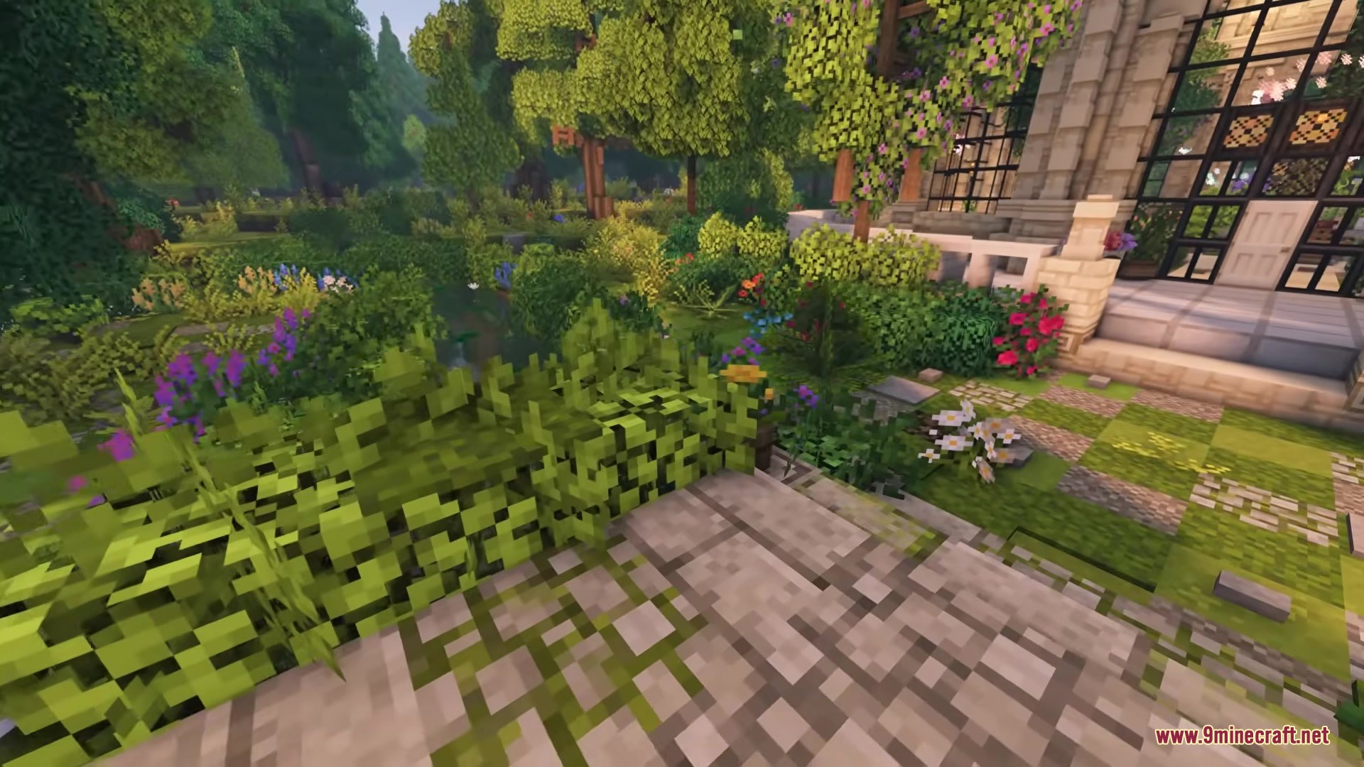 Vibrant flowers and lush greenery surround a stone path in a minecraft garden