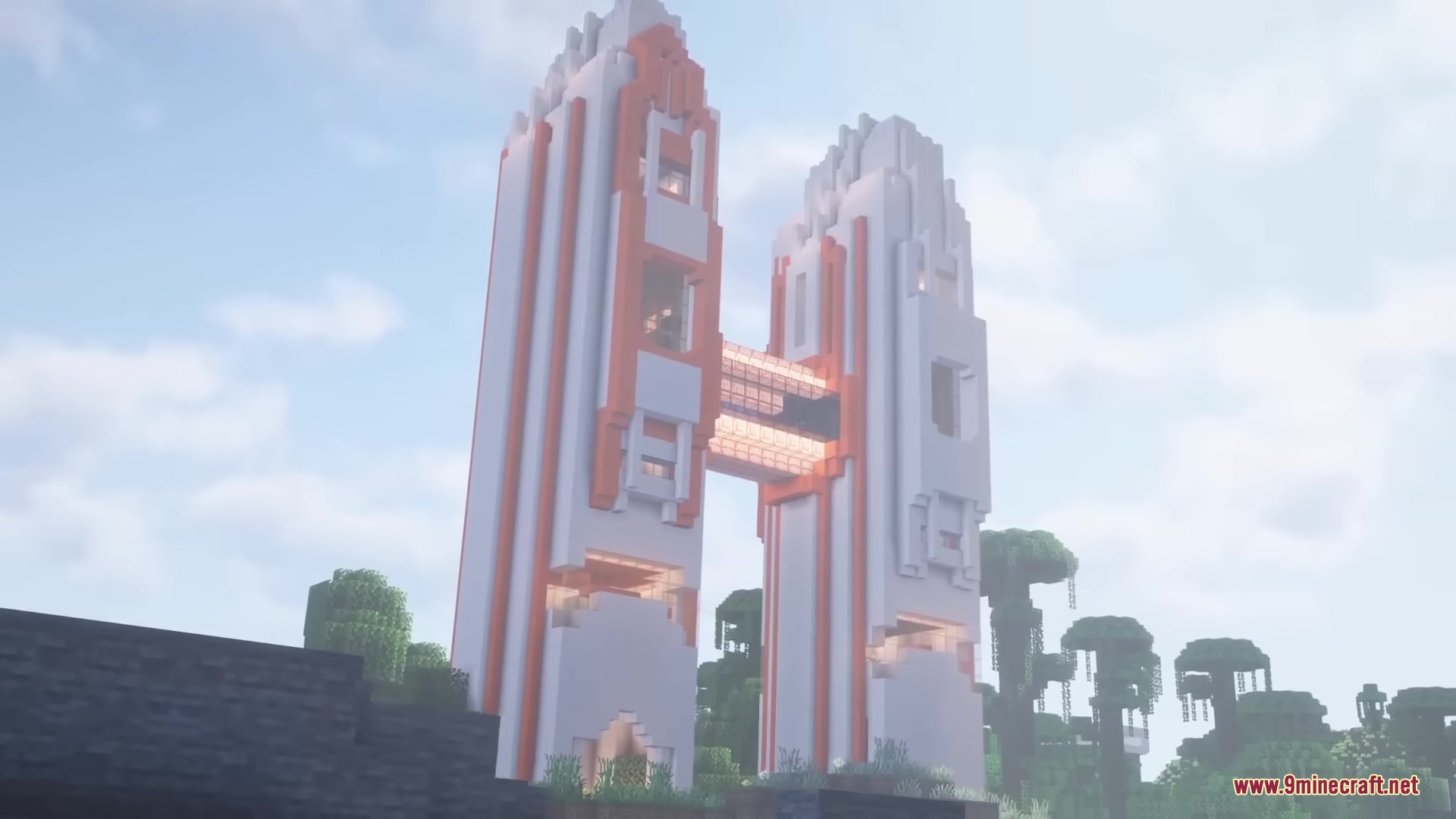 A massive white and orange sci fi tower stands in a green forest