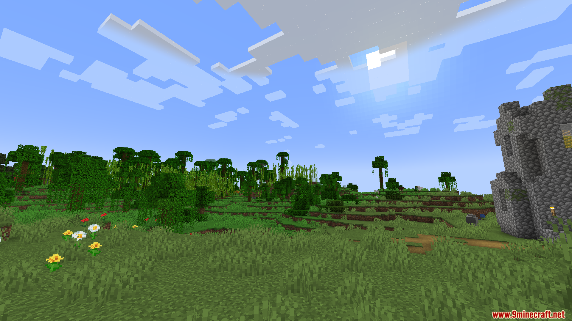 Wide view of a minecraft jungle biome with flowers and stone ruins