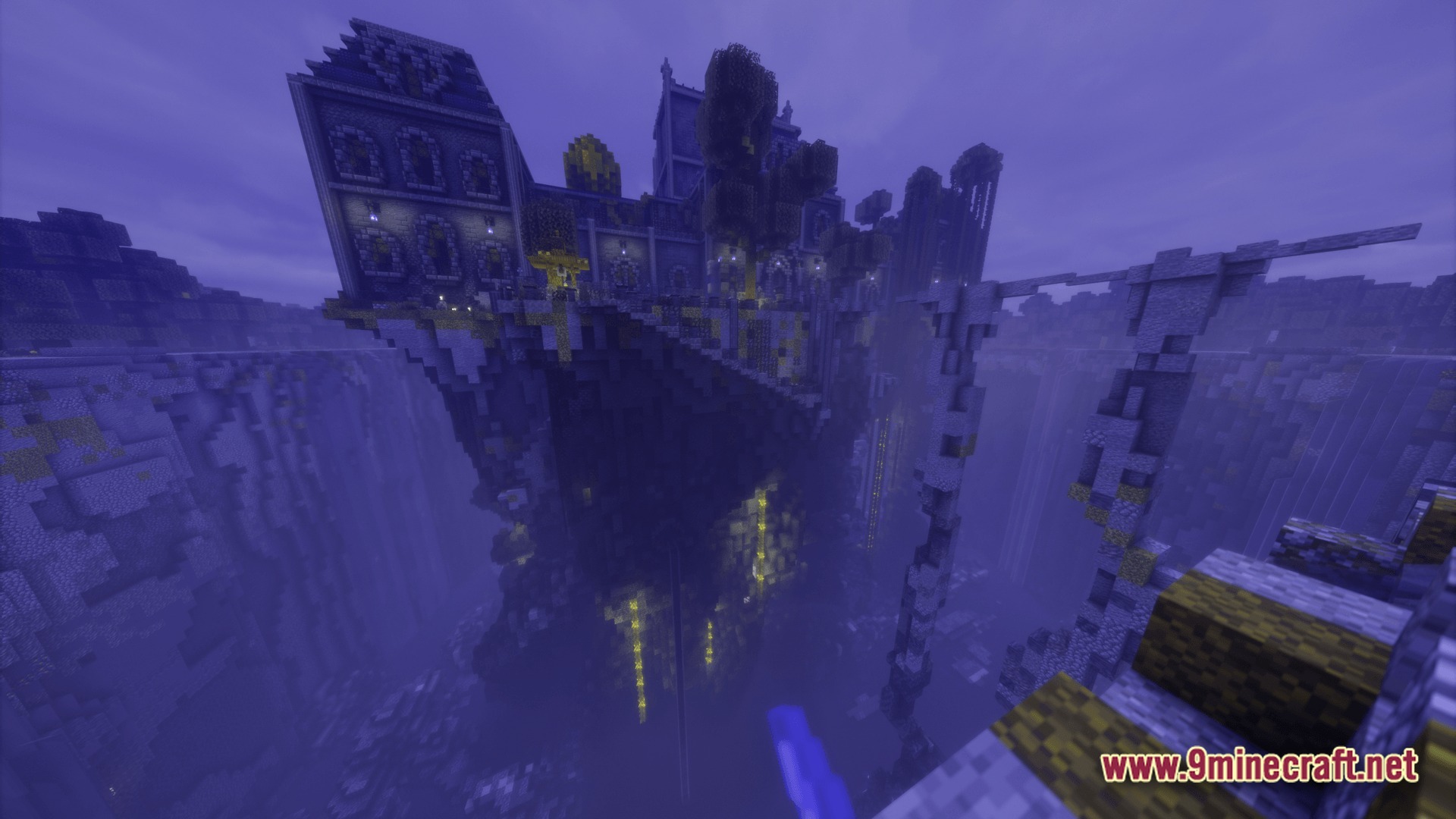 A large stone castle structure built atop a steep cliffside overlooking a deep, foggy ravine