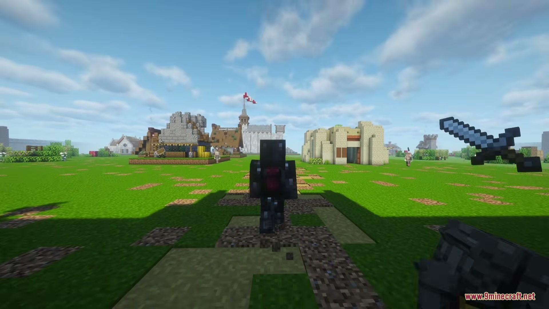 A Game Of Blocks Mod (1.21.1) – Rule Your Own Medieval Kingdom 12 A player in dark armor stands near medieval buildings in a grassy field