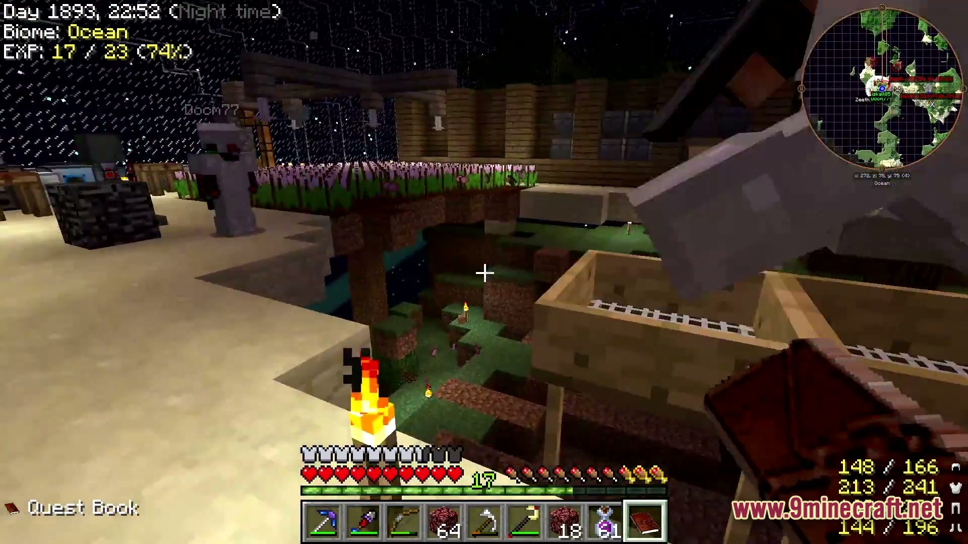 A player stands near a flower farm and wooden structures at night in an ocean biome