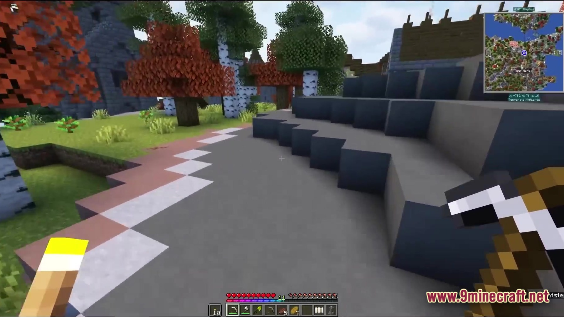 All The Mods 9 Atm9 Modpack (26.2, 1.20.1) – Craft The Ultimate Star 3 A player holds a pickaxe near stone cliffs and autumn trees in a temperate highlands biome