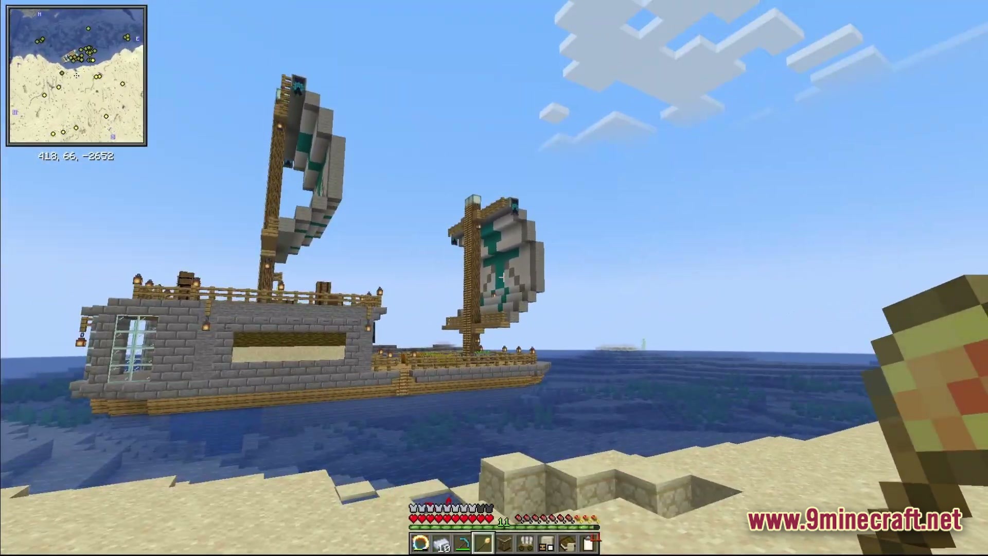 Ancient Kingdoms 3 Modpack (1.20.1) – Build Kingdoms Master Magic Slay 4 A large stone and wood sailing ship anchored in an ocean biome near a sandy beach