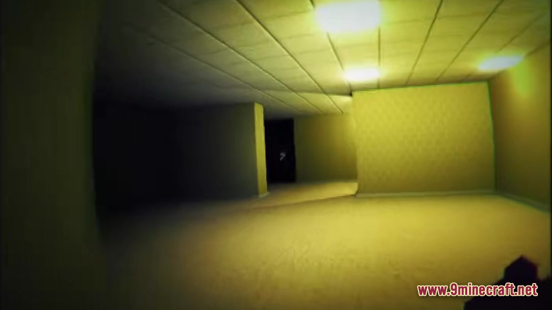 A first-person view of yellow-walled corridors with fluorescent lights in the backrooms level 0