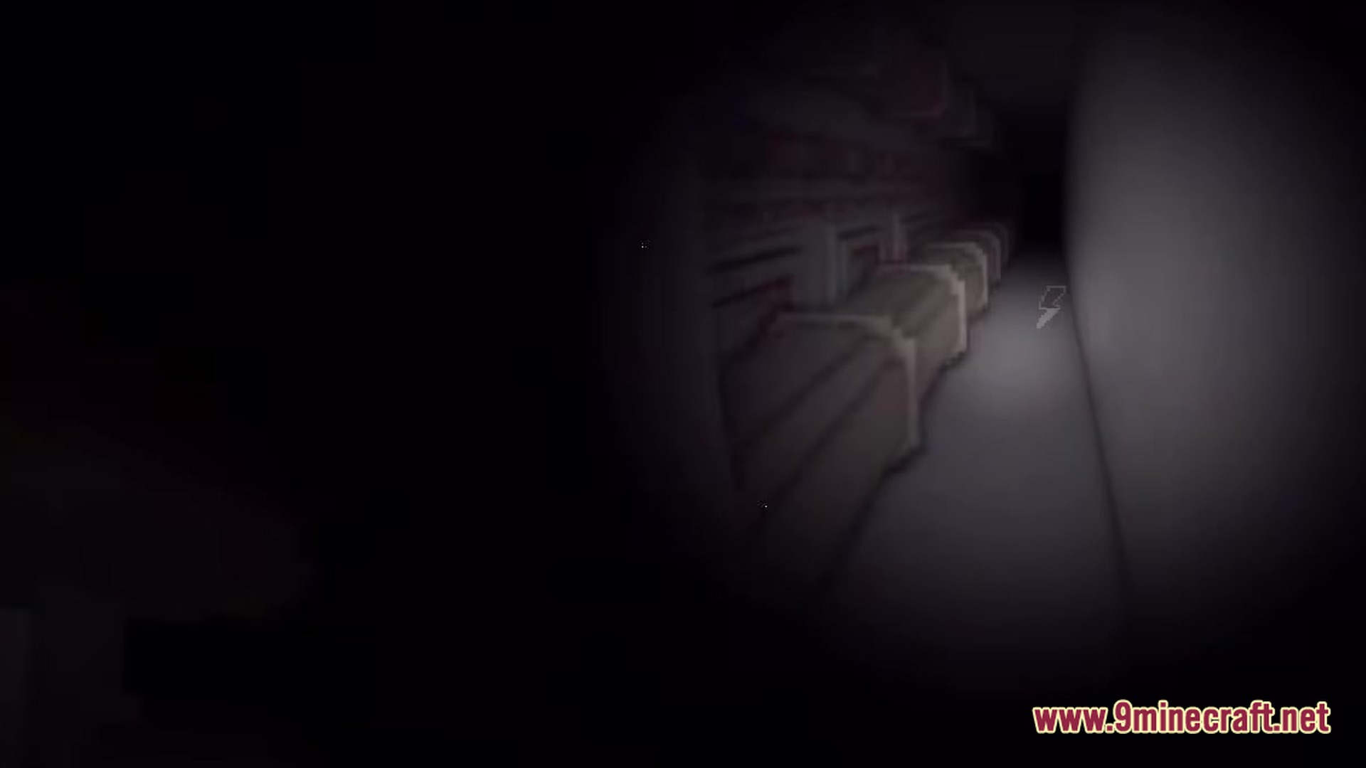 A dark industrial hallway illuminated by a flashlight featuring large pipes and a low battery icon