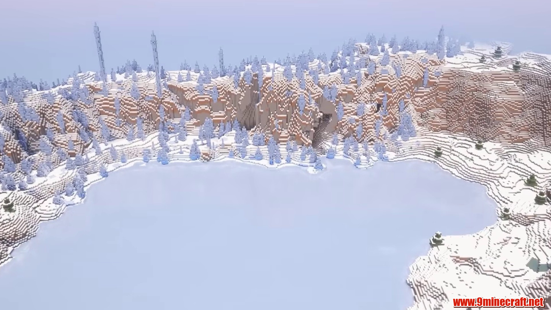 Frozen crater lake surrounded by snowy plains