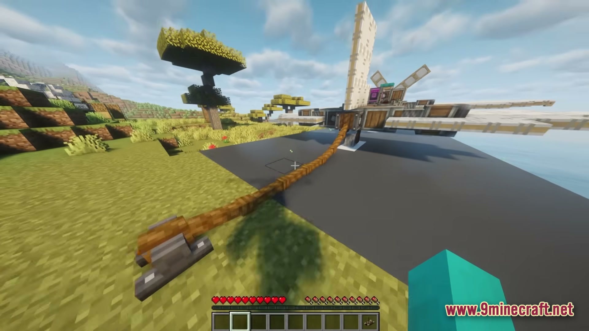 Better Create Aeronautics With Create Addons &Amp; Improvements Modpack (1.21.1) – Build And Fly Custom Aircraft 2 A mechanical aircraft is tethered to a ground anchor on a runway in a savanna biome