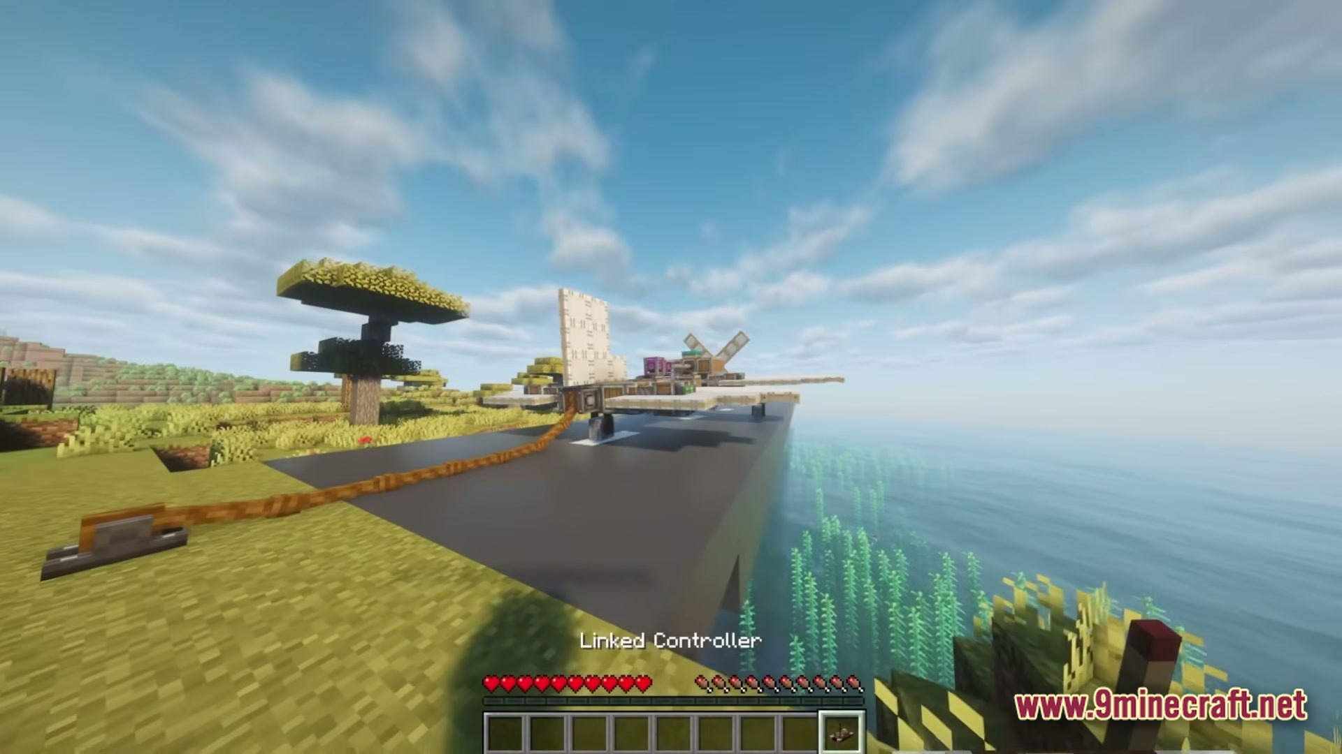 Better Create Aeronautics With Create Addons &Amp; Improvements Modpack (1.21.1) – Build And Fly Custom Aircraft 3 A custom-built aircraft sits on a runway overlooking the ocean in a savanna biome