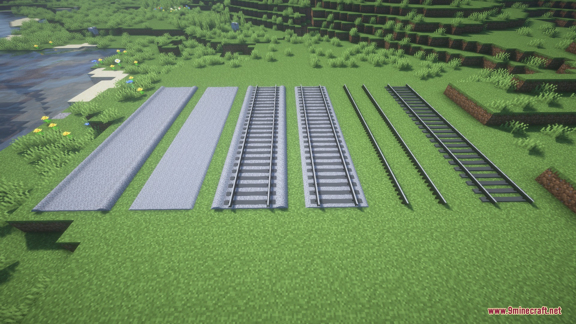 Various realistic railway track components and ballast styles displayed on grass