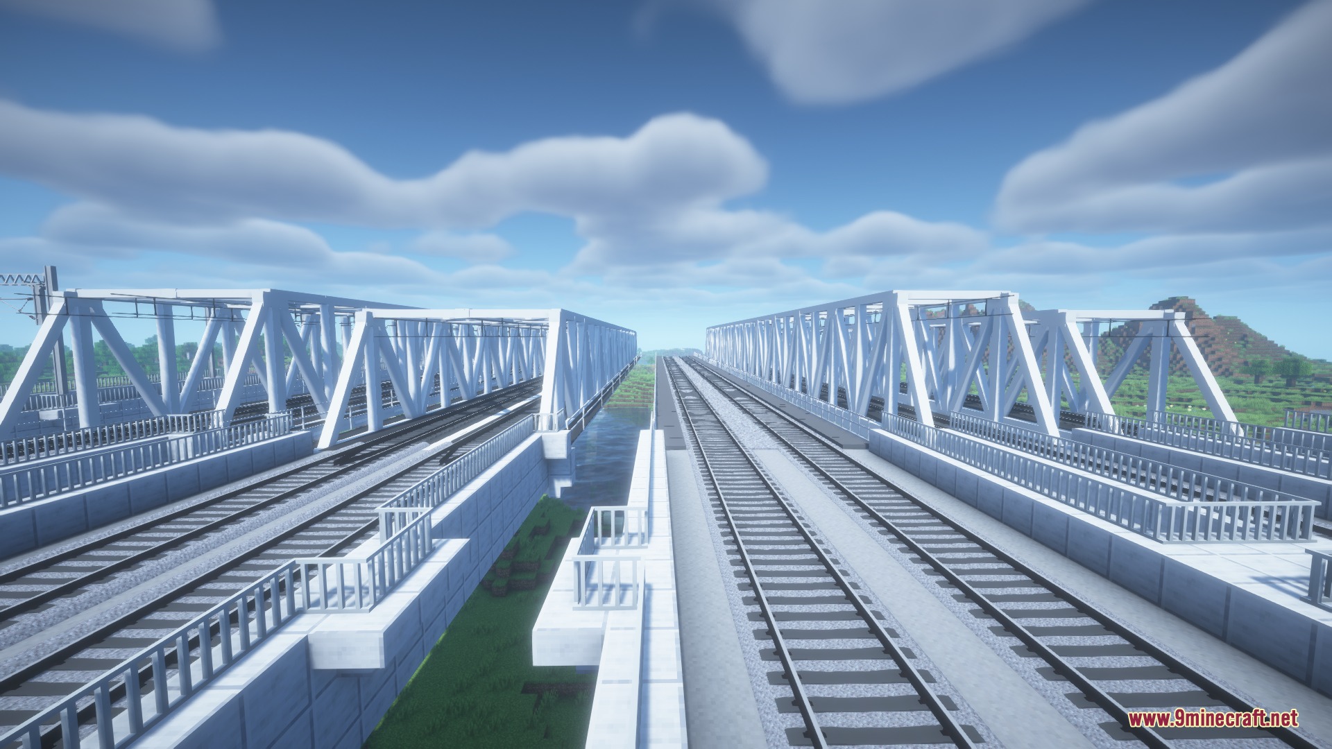 Broad gauge railway tracks crossing white metal truss bridges and concrete embankments