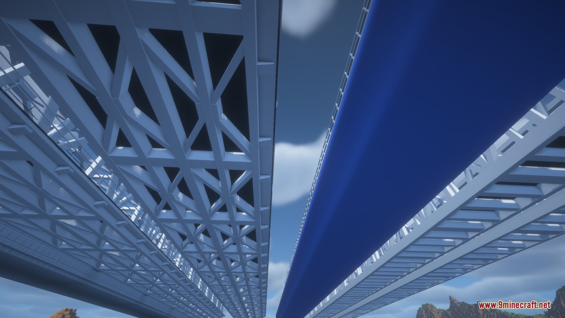 Low angle view showing the detailed white metal truss structures of railway bridges