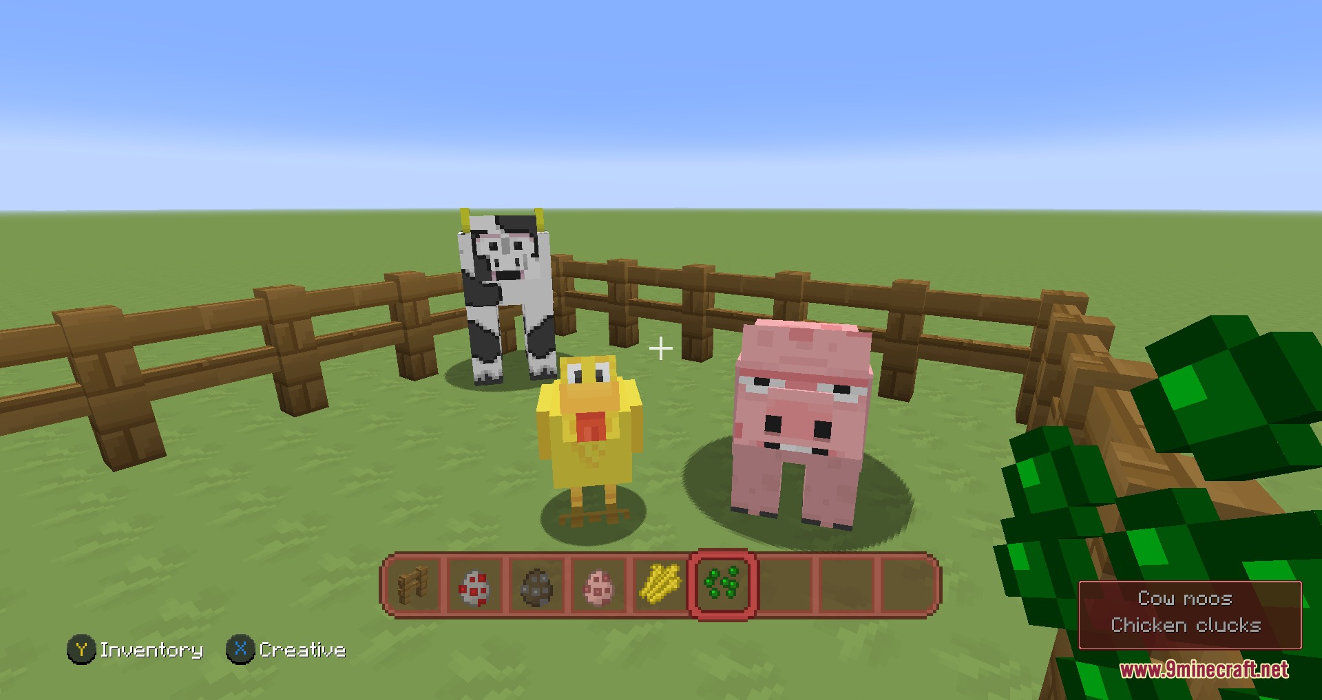 Cartoon style cow chicken and pig standing inside a wooden fence