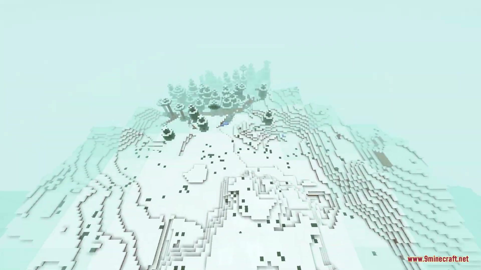 Aerial cinematic view of a snowy mountain biome with trees