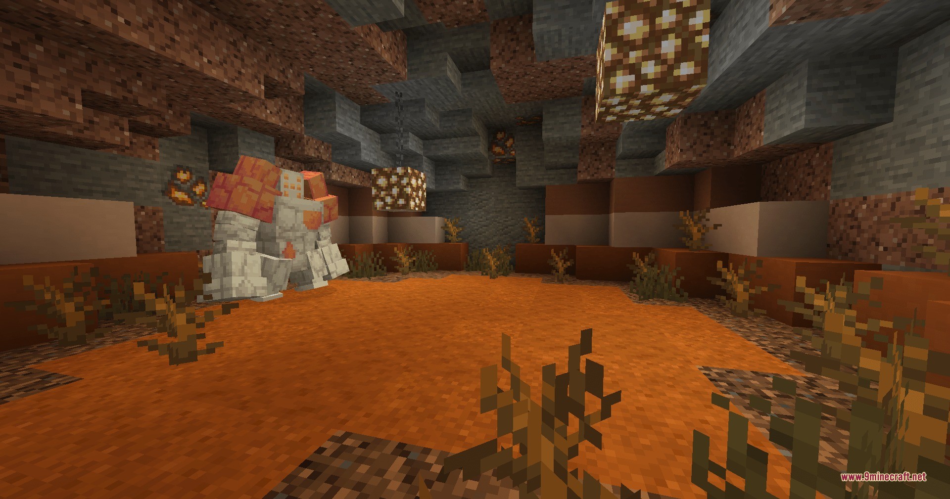A legendary rock creature stands inside a cave with orange sand floors