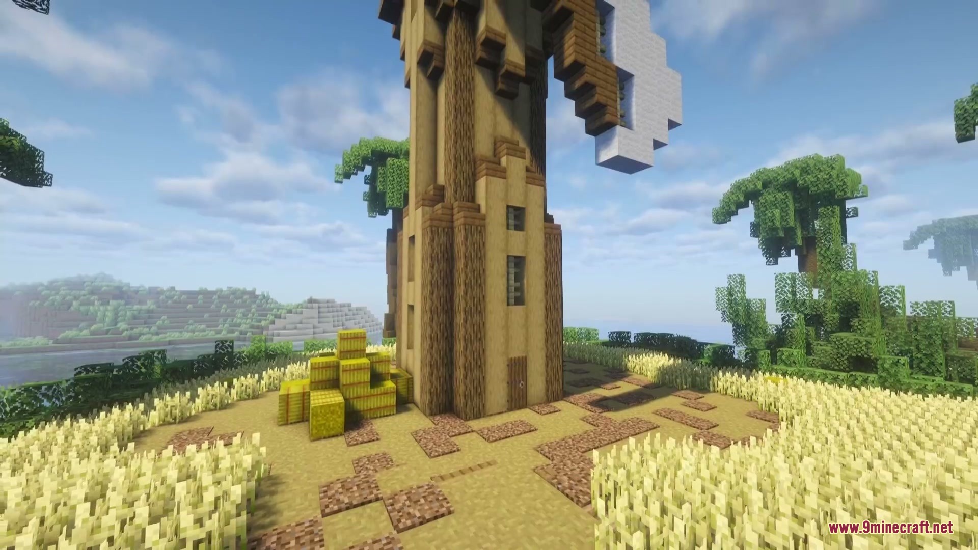 Combustive Ordnance Expansion Mod (26.1.2, 1.20.1) – Turn Tnt Into Realistic 2 A tall wooden windmill tower standing in a field of golden wheat