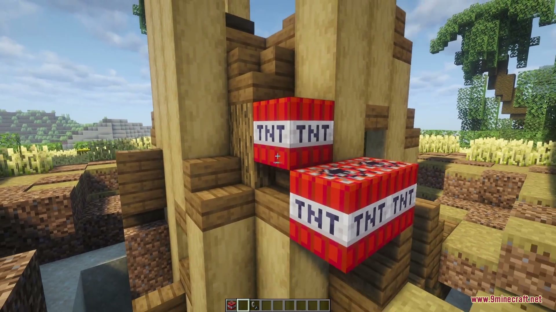 Combustive Ordnance Expansion Mod (26.1.2, 1.20.1) – Turn Tnt Into Realistic 4 A player placing tnt blocks on a wooden tower in a minecraft world