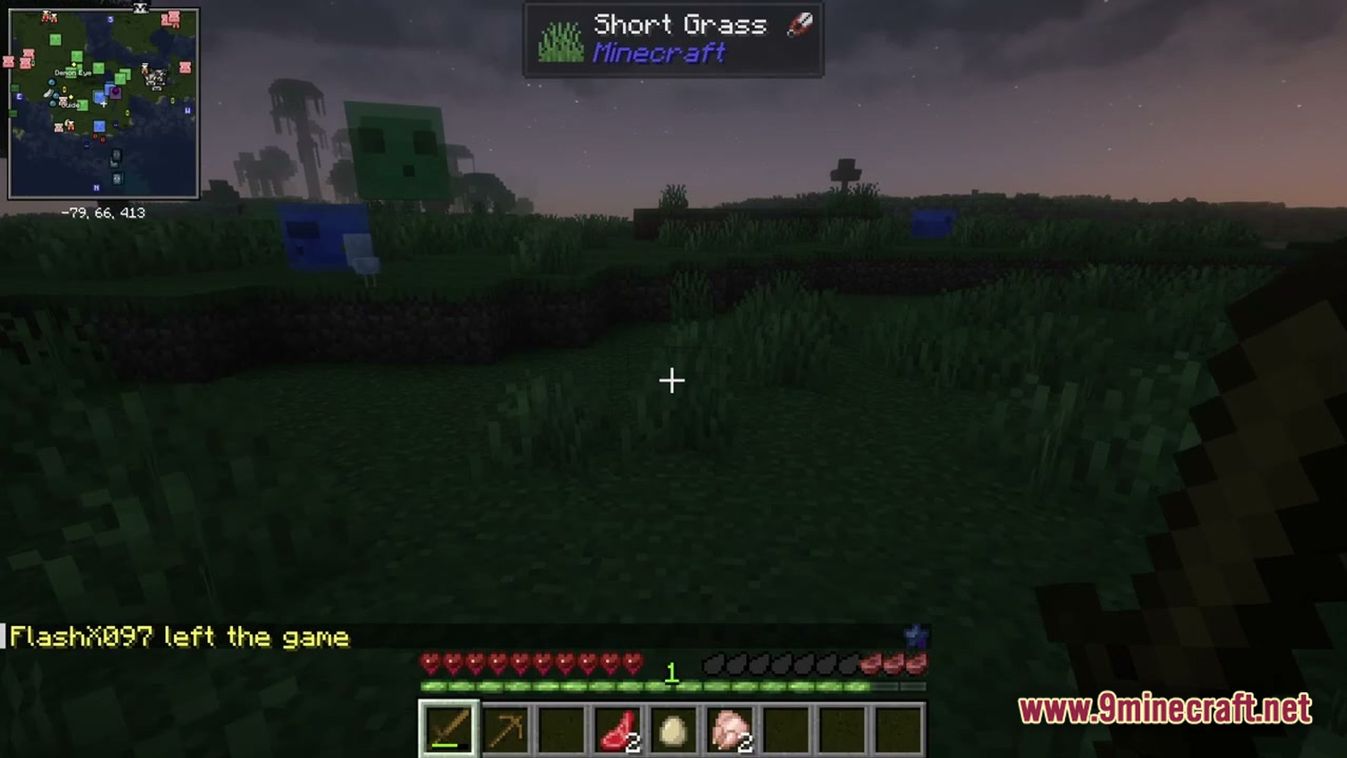 A player holds a wooden sword in a grassy field with slimes nearby at dusk